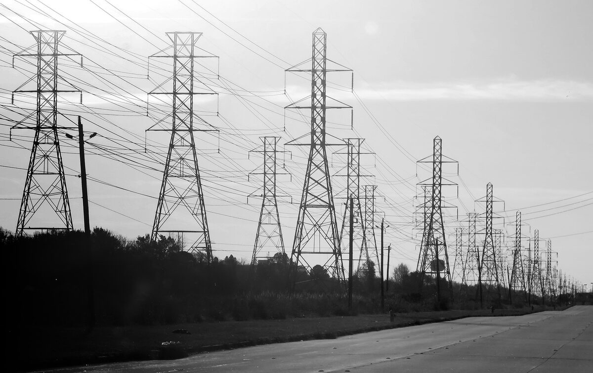 High-voltage electricity transmission towers against the sky